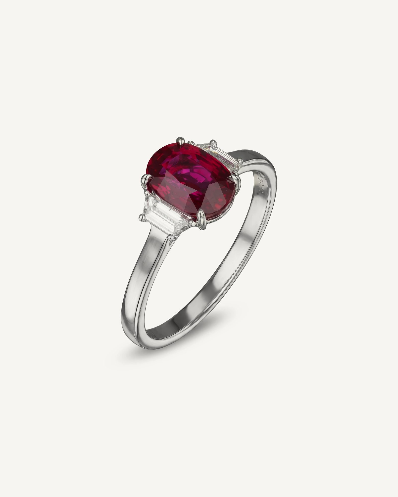 Oval ruby ring with tapered baguette diamond accents