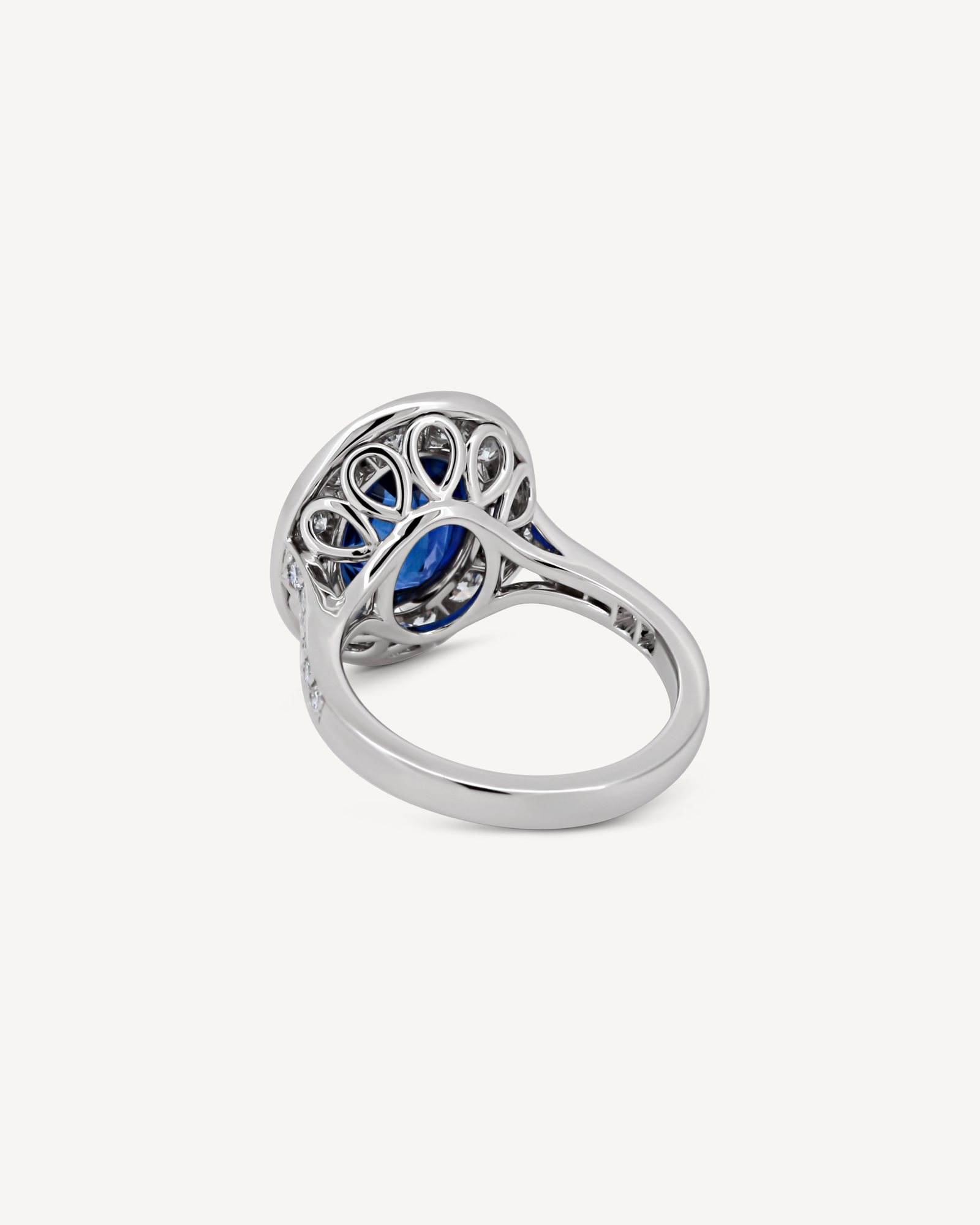 The same sapphire halo ring seen from behind, showing the open gallery
