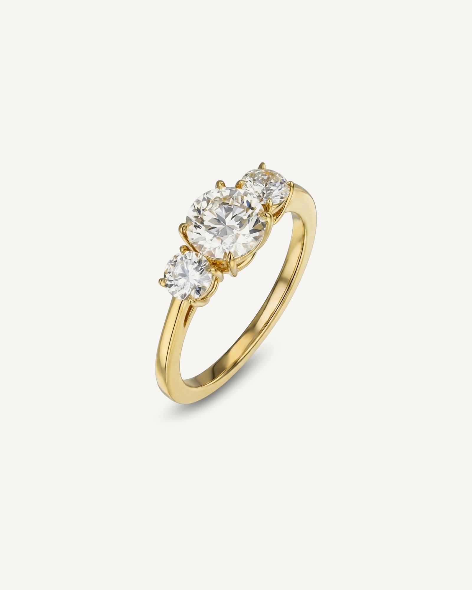 Three-stone round brilliant diamond ring in yellow gold